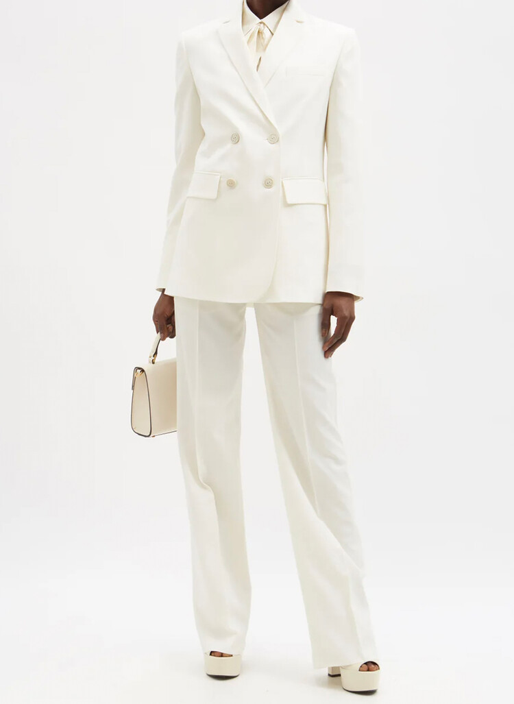 Двубортный блейзер из шерсти и саржи от Valentino, 2100 фунтов стерлингов/ $3500, и подходящие шерстяные брюки с защипами, 1100 фунтов стерлингов/ $1900, Matches Fashion